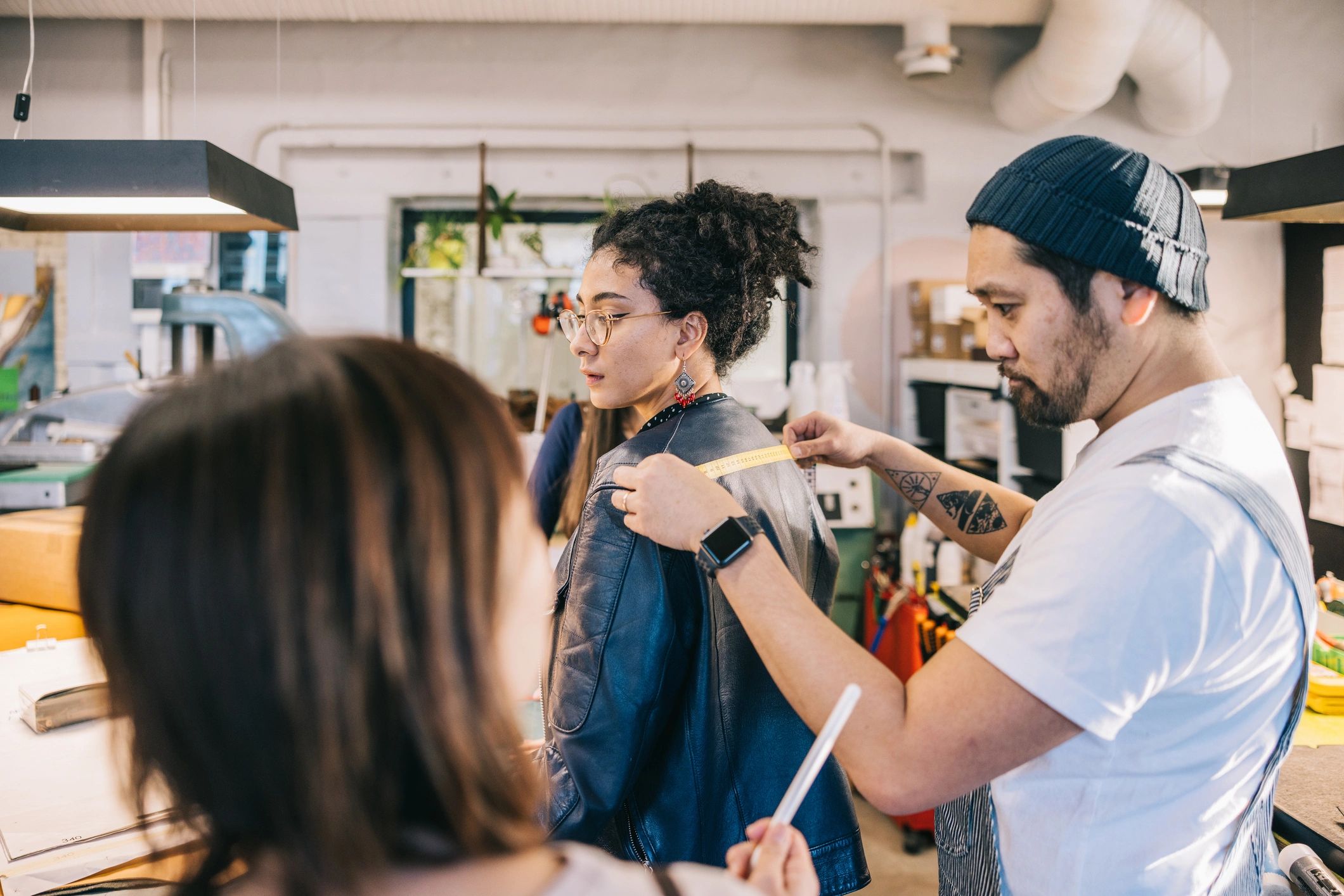 Fashion designers collaborating in a studio